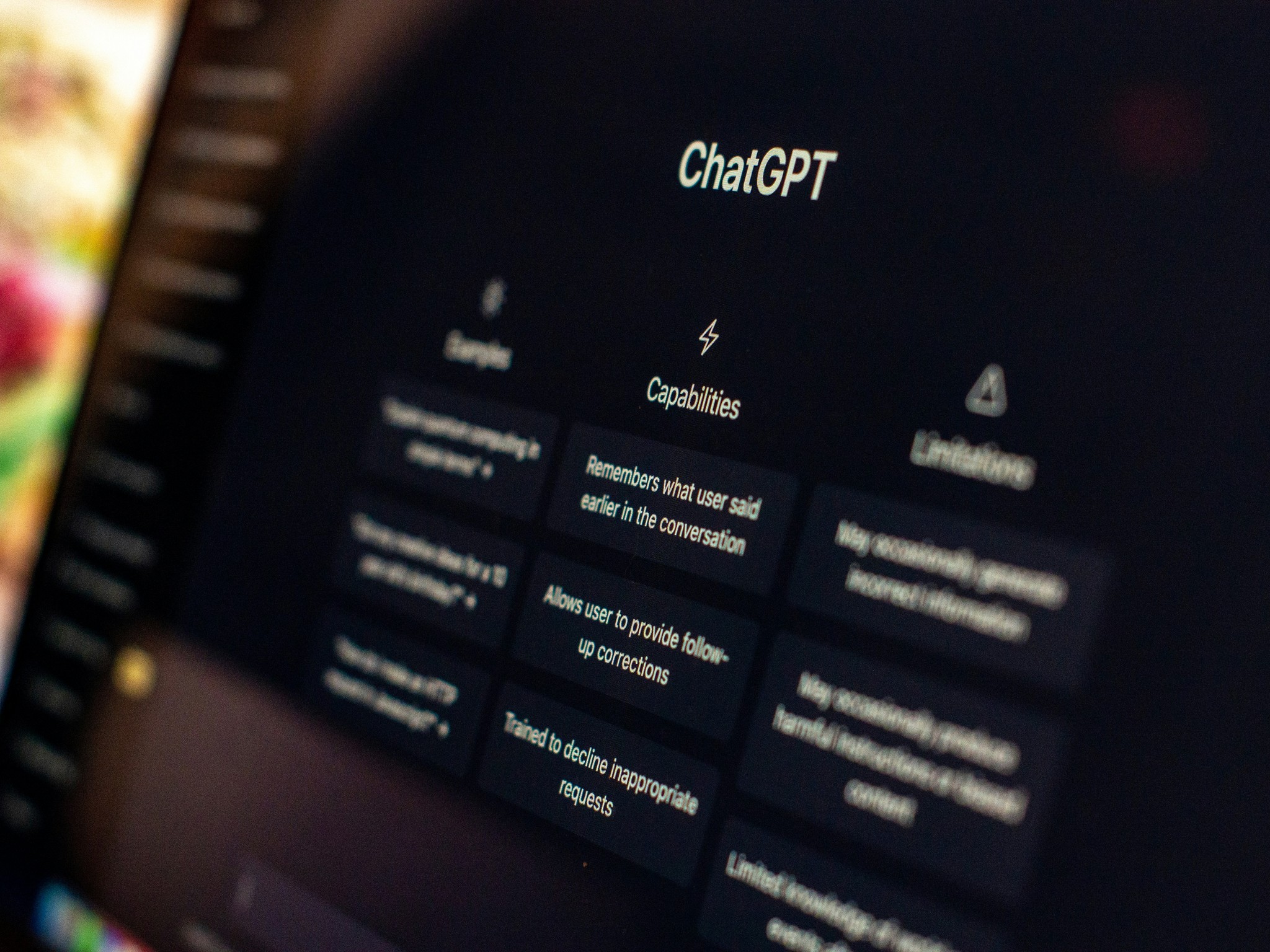 Close-up of a screen displaying the ChatGPT interface, showing the Capabilities section with cards reading "Remembers what user said earlier in the conversation," "Allows user to provide follow-up corrections," and "Trained to decline inappropriate requests."